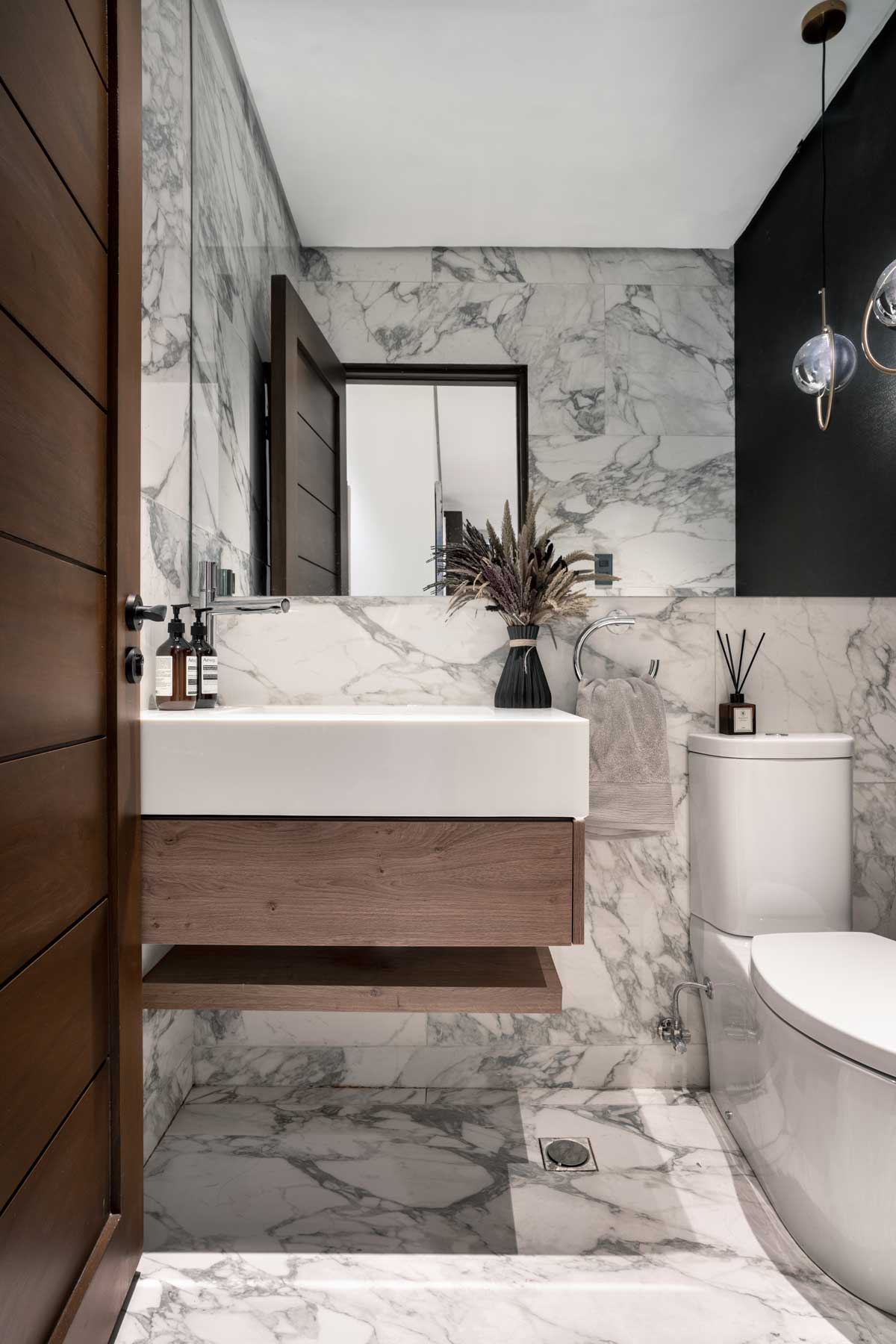 White marble Powder room Interior Design with chrome accents at the Twelve Luxury Flats